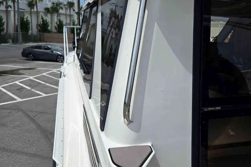 Tranquila Yacht Photos Pics 2023 Cutwater C-288 Coupe side view, showcasing sleek design and windows.