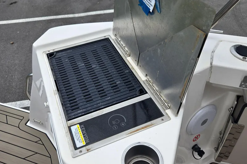 Tranquila Yacht Photos Pics Outdoor grill on 2023 Cutwater C-288 Coupe boat, featuring a sleek design and stainless steel finish.