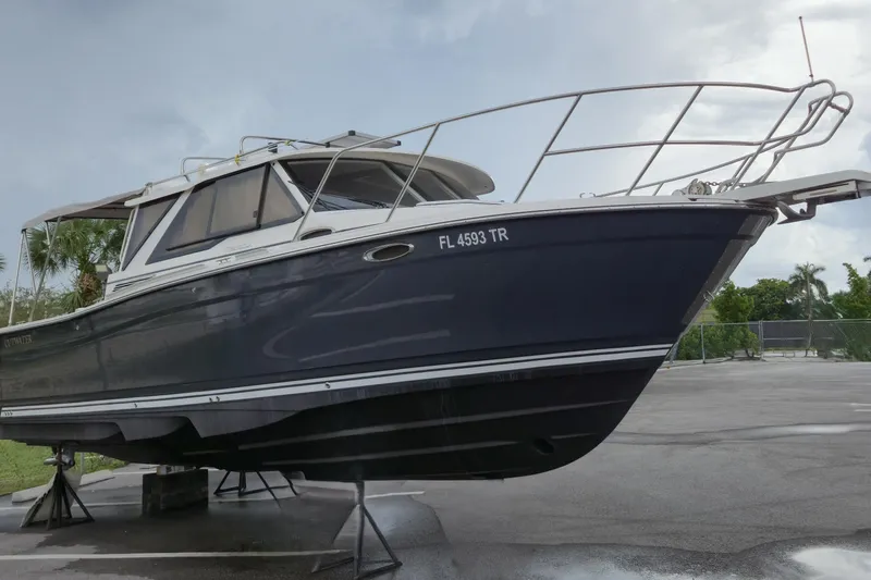 Tranquila Yacht Photos Pics 2023 Cutwater C-288 Coupe boat on stands, side view, outdoors.