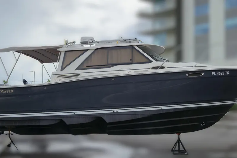 Tranquila Yacht Photos Pics 2023 Cutwater C-288 Coupe boat with sleek design, docked outdoors.