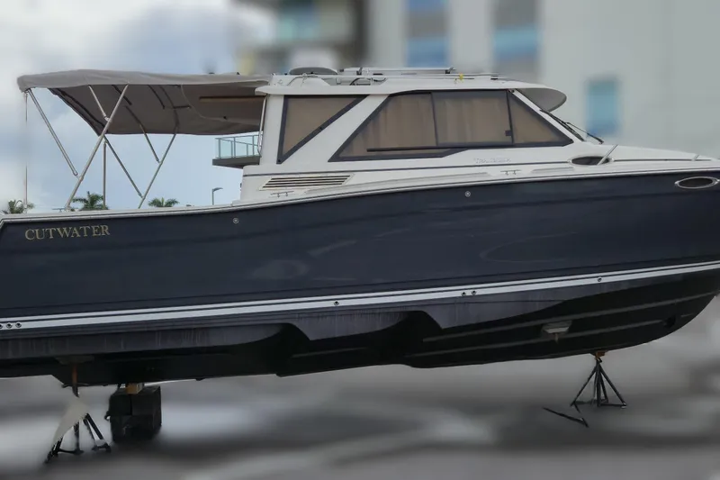 Tranquila Yacht Photos Pics 2023 Cutwater C-288 Coupe boat on stands, side view, with canopy.