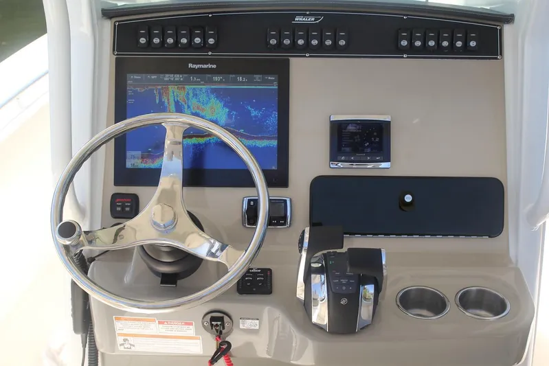  Yacht Photos Pics Manufacturer Provided Image: 2025 Boston Whaler 250 Outrage helm with advanced navigation system and controls.