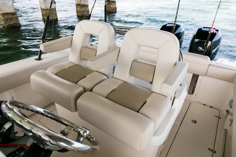  Yacht Photos Pics Manufacturer Provided Image: 2025 Boston Whaler 250 Outrage boat interior with plush seating and dual outboard motors.