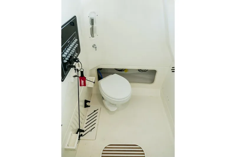  Yacht Photos Pics Manufacturer Provided Image: Interior of 2025 Boston Whaler 250 Outrage boat, featuring a compact marine toilet.