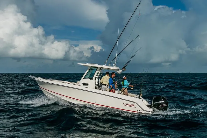  Yacht Photos Pics Manufacturer Provided Image: 2025 Boston Whaler 250 Outrage boat navigating ocean waves under cloudy sky.