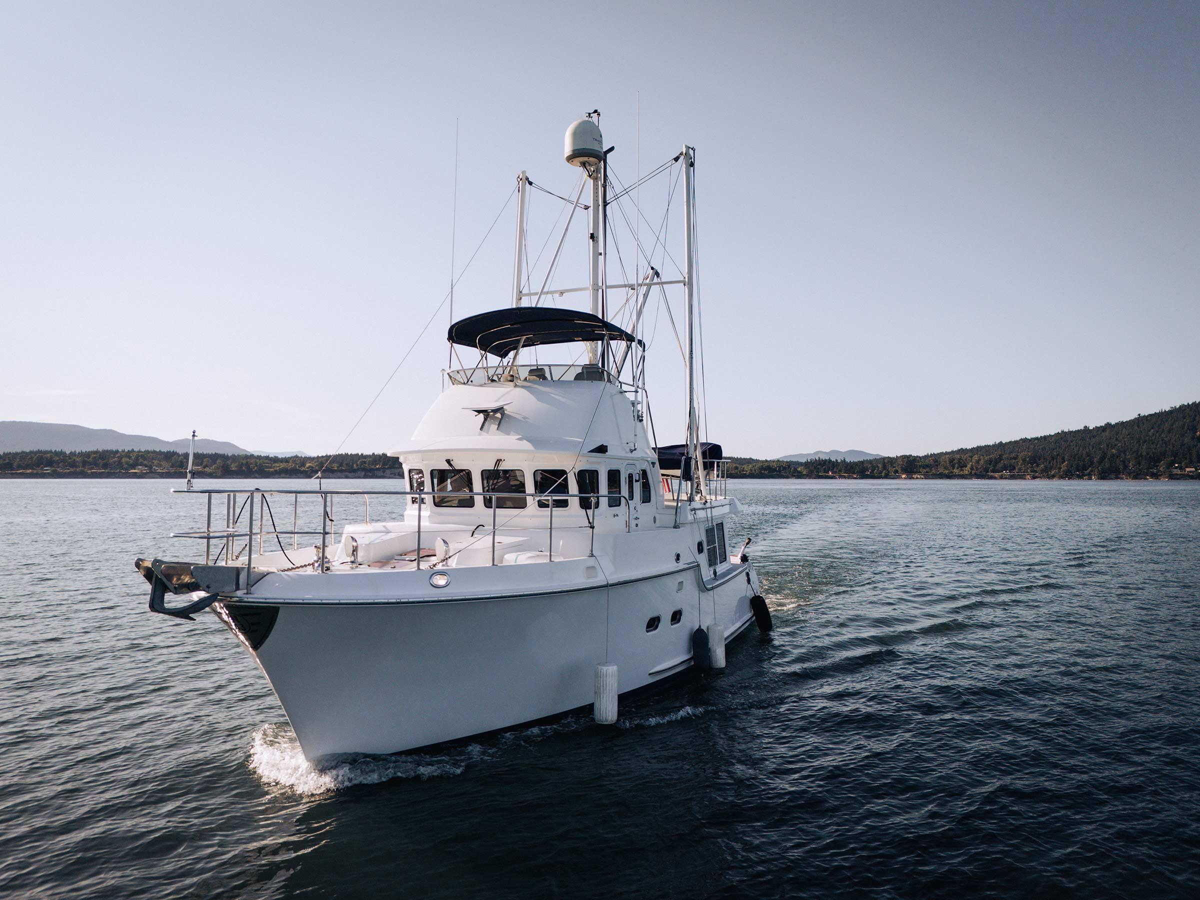 2004 Nordhavn 43 yacht cruising on calm waters under clear skies.