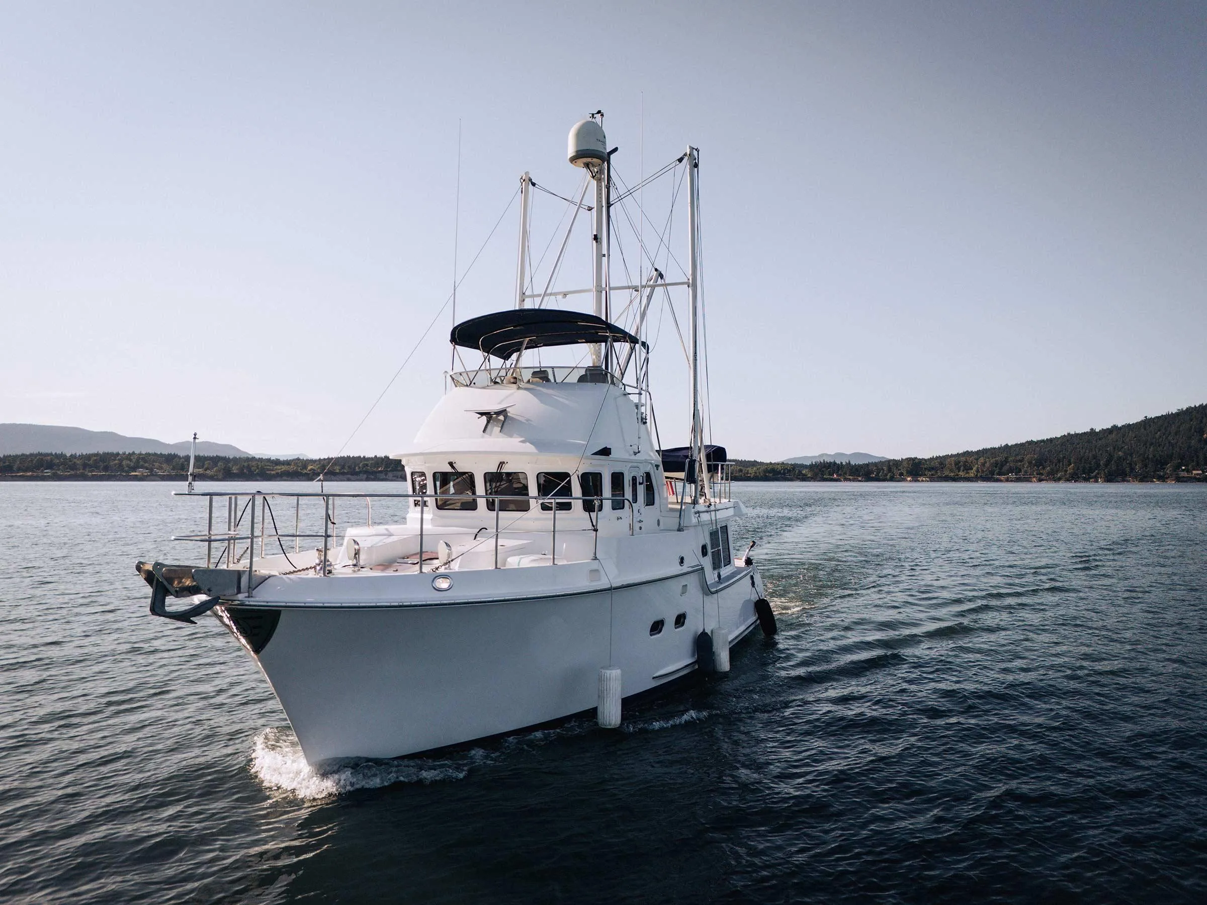 2004 Nordhavn 43 yacht cruising on calm waters under clear skies.