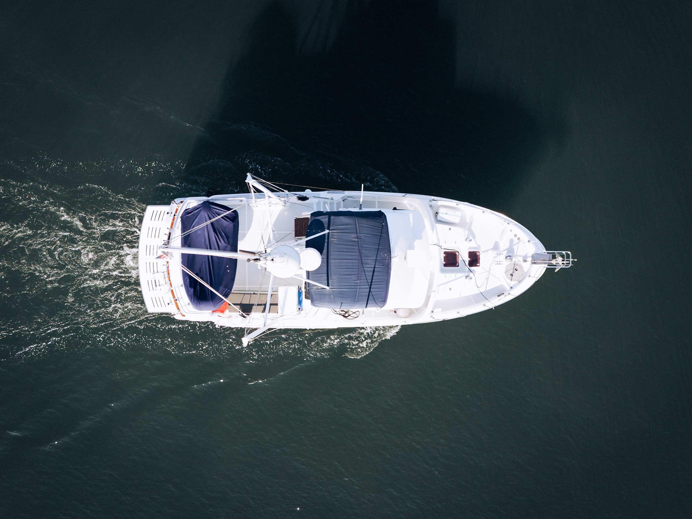 Aerial view of a 2004 Nordhavn 43 yacht cruising on calm waters.