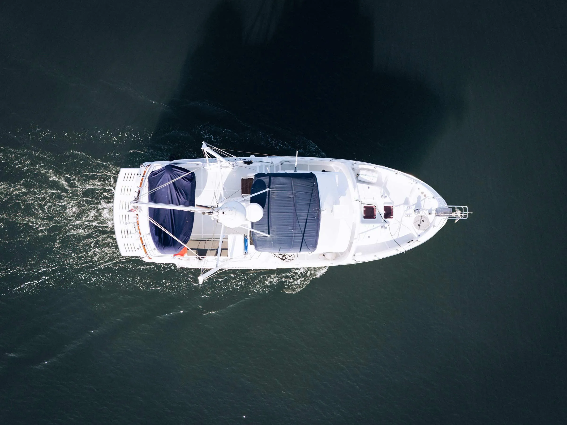 Aerial view of a 2004 Nordhavn 43 yacht cruising on calm waters.
