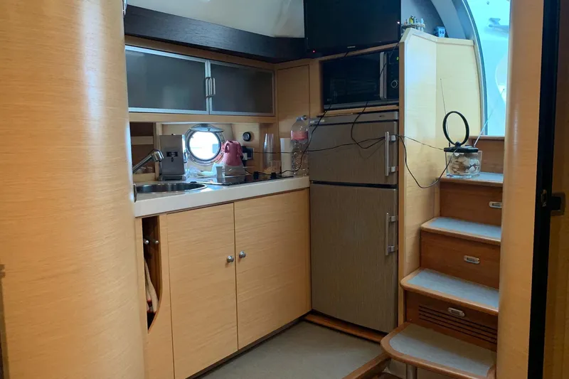  Yacht Photos Pics 2009 Cranchi Mediterranee 43 HT yacht interior kitchen with wooden cabinets and modern appliances.