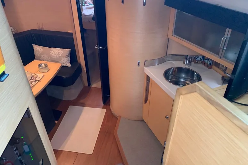  Yacht Photos Pics Interior of 2009 Cranchi Mediterranee 43 HT yacht, featuring kitchenette and seating area.