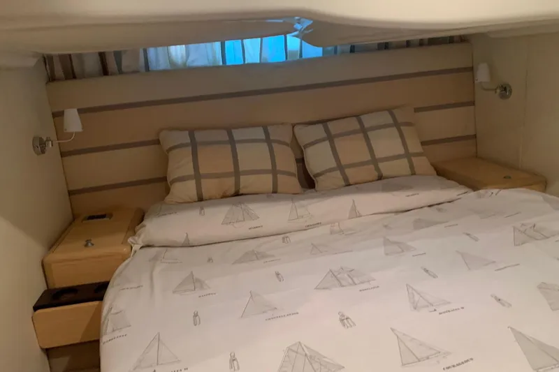  Yacht Photos Pics Luxurious bedroom interior of 2009 Cranchi Mediterranee 43 HT yacht with nautical-themed bedding.
