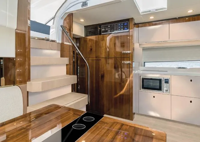 New For 2026 Yacht Photos Pics Luxurious 2025 Fairline Targa 50 Open yacht interior with modern kitchen and wooden finishes.