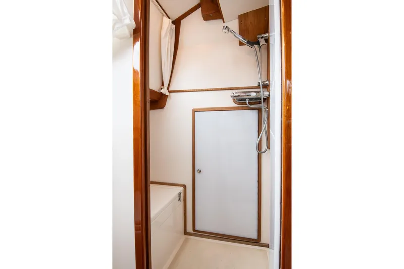 Next Boat Yacht Photos Pics Bathroom interior of 2007 Morris Ocean Series 45 yacht, featuring shower and wooden accents.