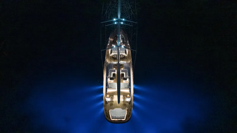 Atlantika Yacht Photos Pics Aerial view of illuminated 2013 custom sailing yacht on dark water.