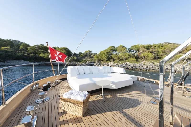 Atlantika Yacht Photos Pics Luxurious 2013 custom sailing yacht deck with white seating, scenic coastal view.