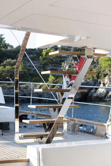 Atlantika Yacht Photos Pics Modern staircase on a 2013 custom sailing yacht, with sleek design and scenic background.