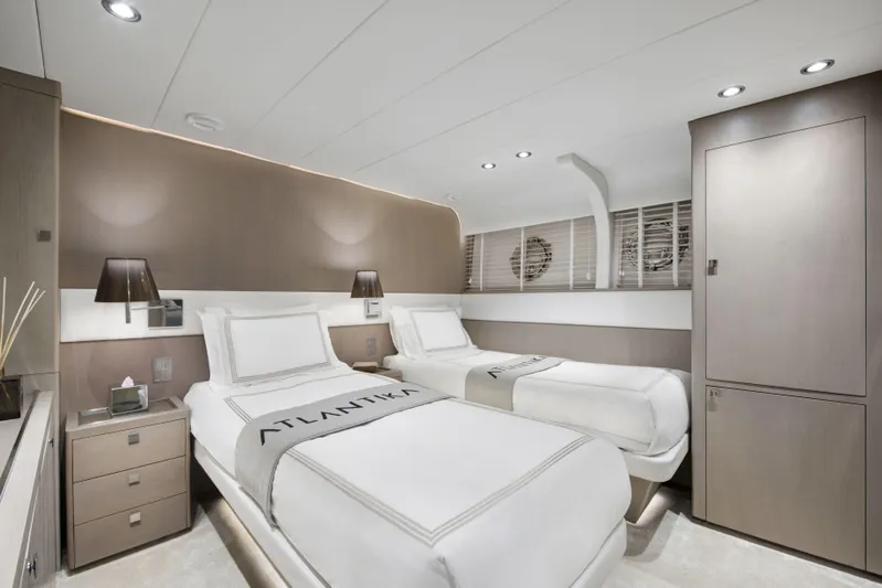 Atlantika Yacht Photos Pics Luxurious twin bedroom in a 2013 custom sailing yacht, featuring modern decor and ambient lighting.