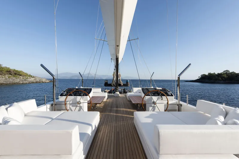 Atlantika Yacht Photos Pics Luxurious 2013 custom sailing yacht with white seating, wooden deck, and scenic ocean view.