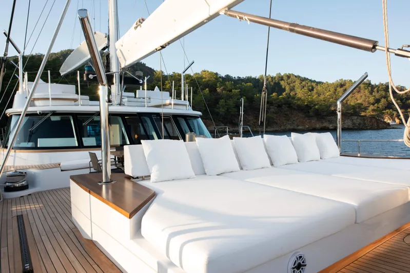 Atlantika Yacht Photos Pics Luxurious 2013 custom sailing yacht with spacious deck and plush seating, set against a scenic backdrop.
