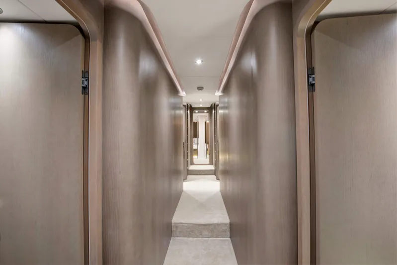 Atlantika Yacht Photos Pics Luxurious hallway inside a 2013 custom sailing yacht, featuring sleek wooden paneling.