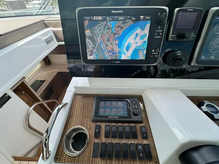  Yacht Photos Pics Control panel of 2015 Cruisers Yachts 48 Cantius with navigation and monitoring systems.