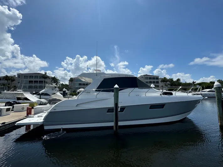  Yacht Photos Pics 2015 Cruisers Yachts 48 Cantius docked at marina under clear blue sky.