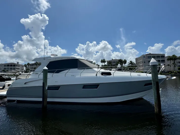  Yacht Photos Pics 2015 Cruisers Yachts 48 Cantius docked in a sunny marina setting.