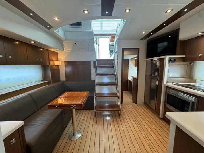  Yacht Photos Pics Luxurious interior of 2015 Cruisers Yachts 48 Cantius with modern kitchen and seating area.