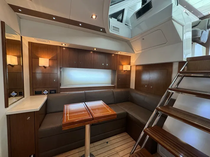  Yacht Photos Pics Luxurious interior of 2015 Cruisers Yachts 48 Cantius with elegant wood finishes and cozy seating.