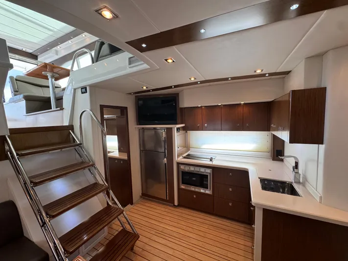  Yacht Photos Pics Luxurious interior of 2015 Cruisers Yachts 48 Cantius with modern kitchen and elegant wood finishes.