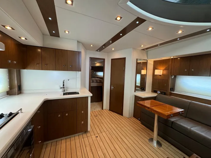  Yacht Photos Pics Luxurious interior of 2015 Cruisers Yachts 48 Cantius with modern kitchen and seating area.