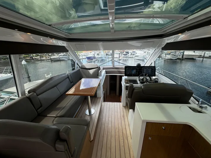  Yacht Photos Pics Luxurious interior of 2015 Cruisers Yachts 48 Cantius with spacious seating and helm.