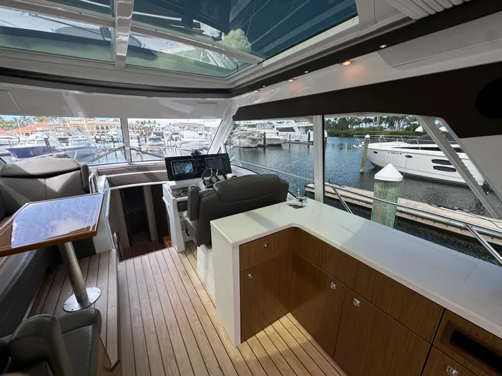  Yacht Photos Pics Luxurious interior of 2015 Cruisers Yachts 48 Cantius with modern helm and waterfront view.