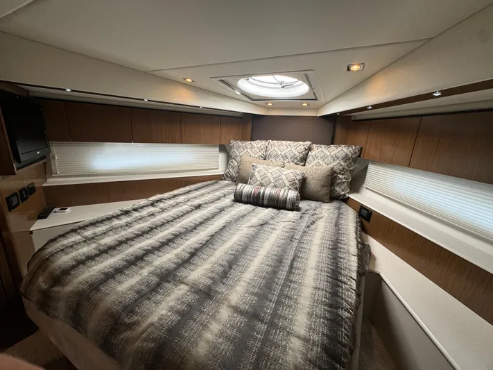  Yacht Photos Pics Luxurious bedroom interior of 2015 Cruisers Yachts 48 Cantius with elegant bedding and modern design.