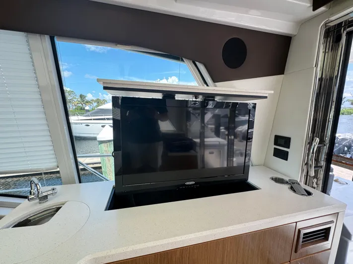  Yacht Photos Pics 2015 Cruisers Yachts 48 Cantius interior with pop-up TV and scenic window view.