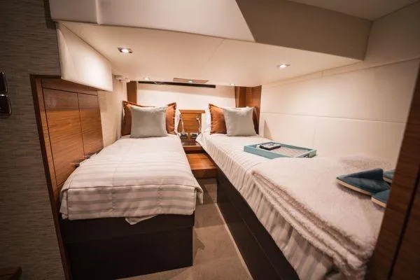 No Agenda Yacht Photos Pics Luxurious twin cabin interior of 2016 Tiara Yachts C44 Coupe, featuring elegant bedding.