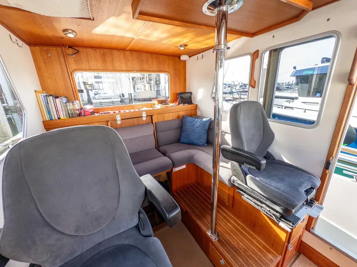  Yacht Photos Pics Interior of 2018 Targa 27.1 boat with seating, windows, and wooden accents.