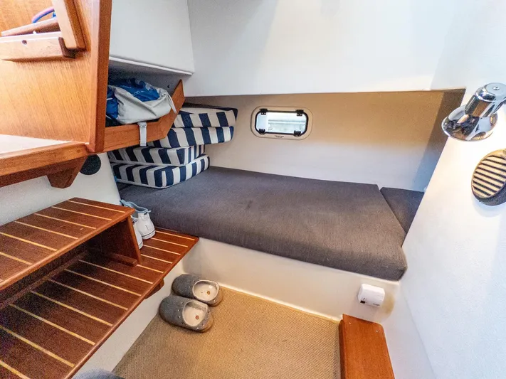  Yacht Photos Pics Cozy cabin interior of 2018 Targa 27.1 boat with wooden steps and bedding.
