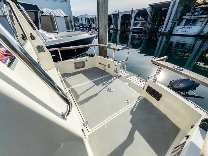  Yacht Photos Pics 2018 Targa 27.1 boat deck with railing, docked at marina.