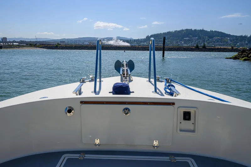  Yacht Photos Pics Bow view of 2018 Targa 27.1 boat on calm water with scenic background.