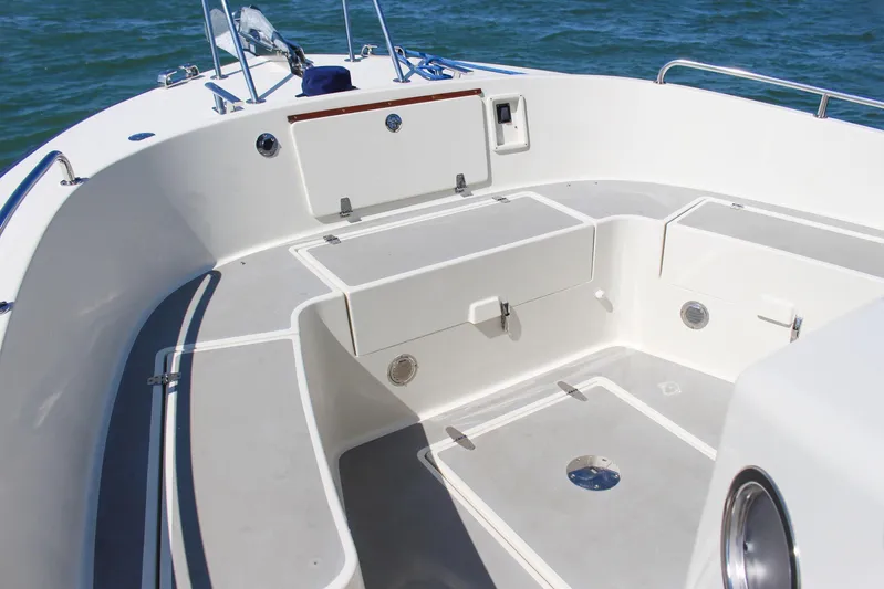  Yacht Photos Pics 2018 Targa 27.1 boat deck with storage compartments, on calm water.