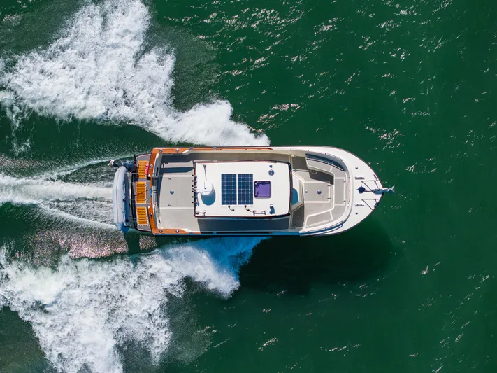  Yacht Photos Pics Aerial view of 2018 Targa 27.1 boat cruising on green water.