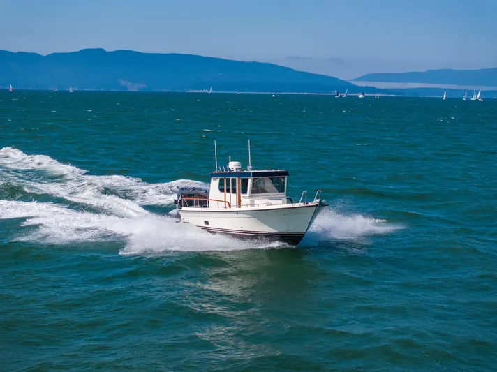  Yacht Photos Pics 2018 Targa 27.1 boat cruising on open sea with distant mountains.