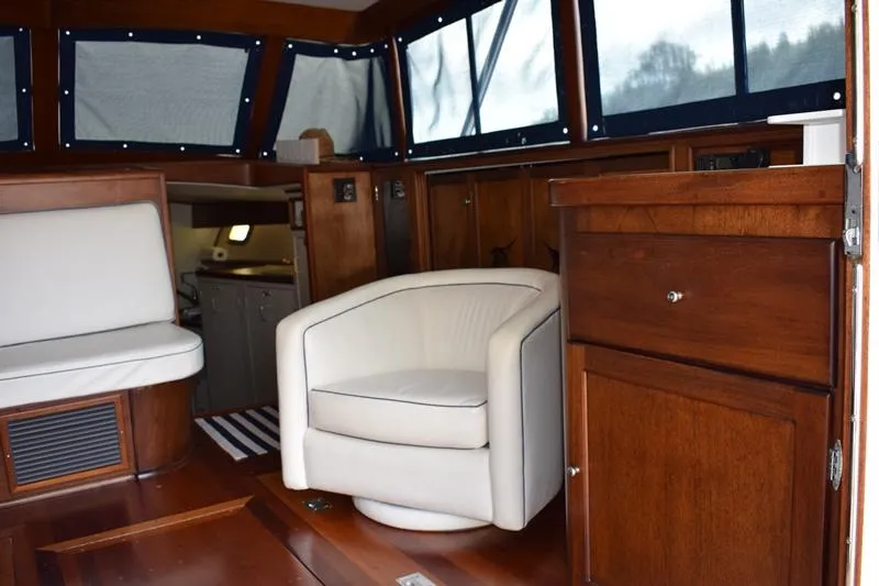 Cygnet Yacht Photos Pics Interior of a 1960 Rybovich Sportfisherman with wooden furnishings and white seating.