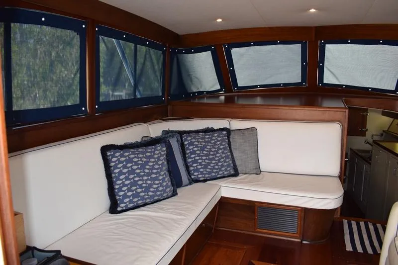 Cygnet Yacht Photos Pics Interior of a 1960 Rybovich Sportfisherman with white sofa and blue cushions.