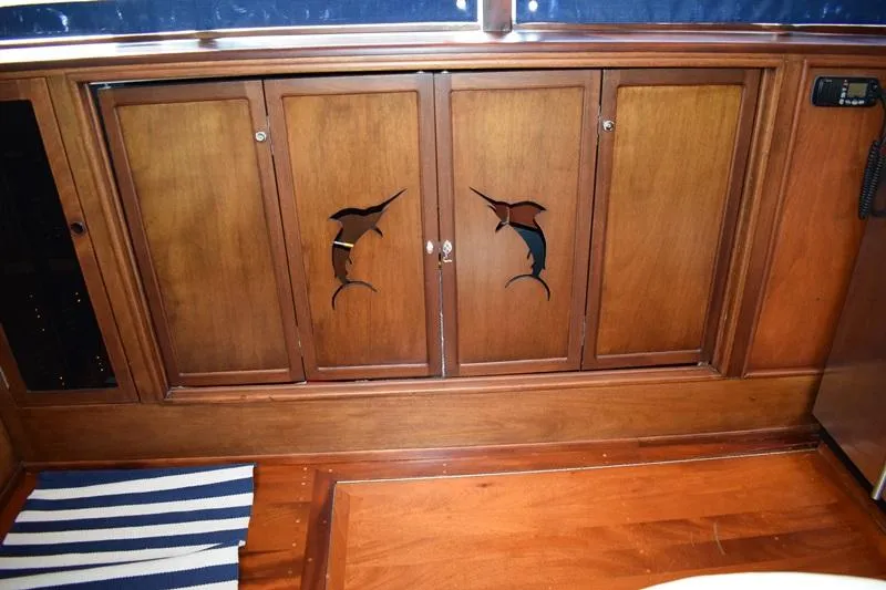Cygnet Yacht Photos Pics Wooden cabinets with fish carvings on a 1960 Rybovich Sportfisherman boat.