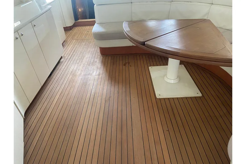  Yacht Photos Pics Interior of 2000 Sunseeker Predator 80 yacht with wooden flooring and seating area.