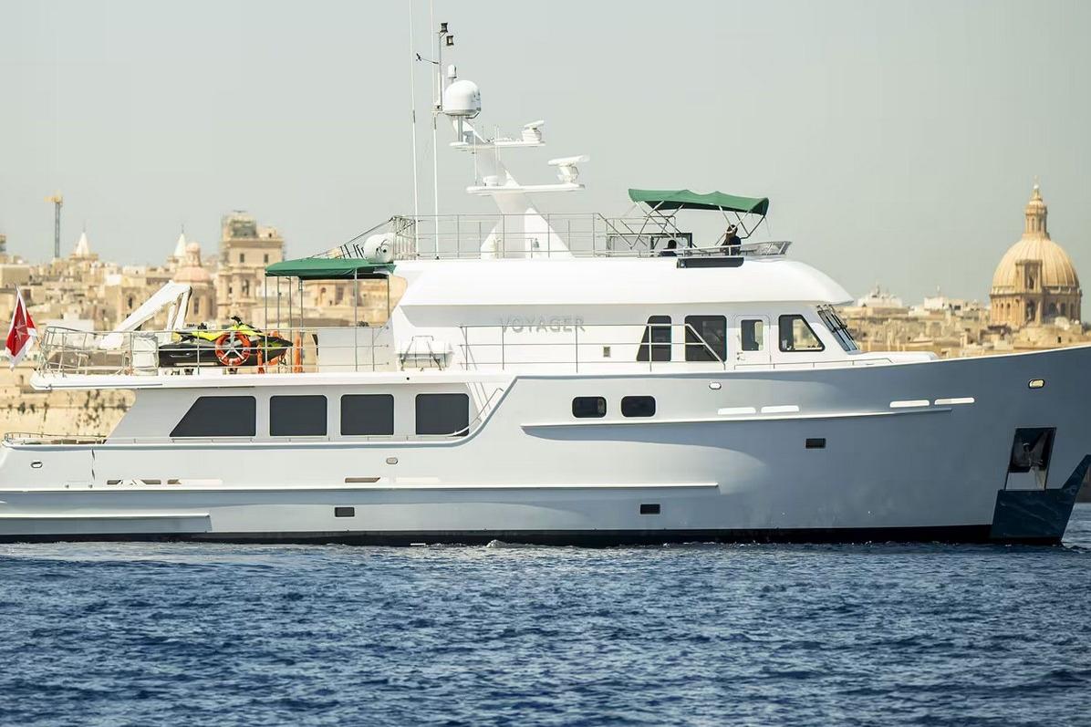 Explorer Seaton 85 yacht, 2004 model, cruising near historic cityscape.