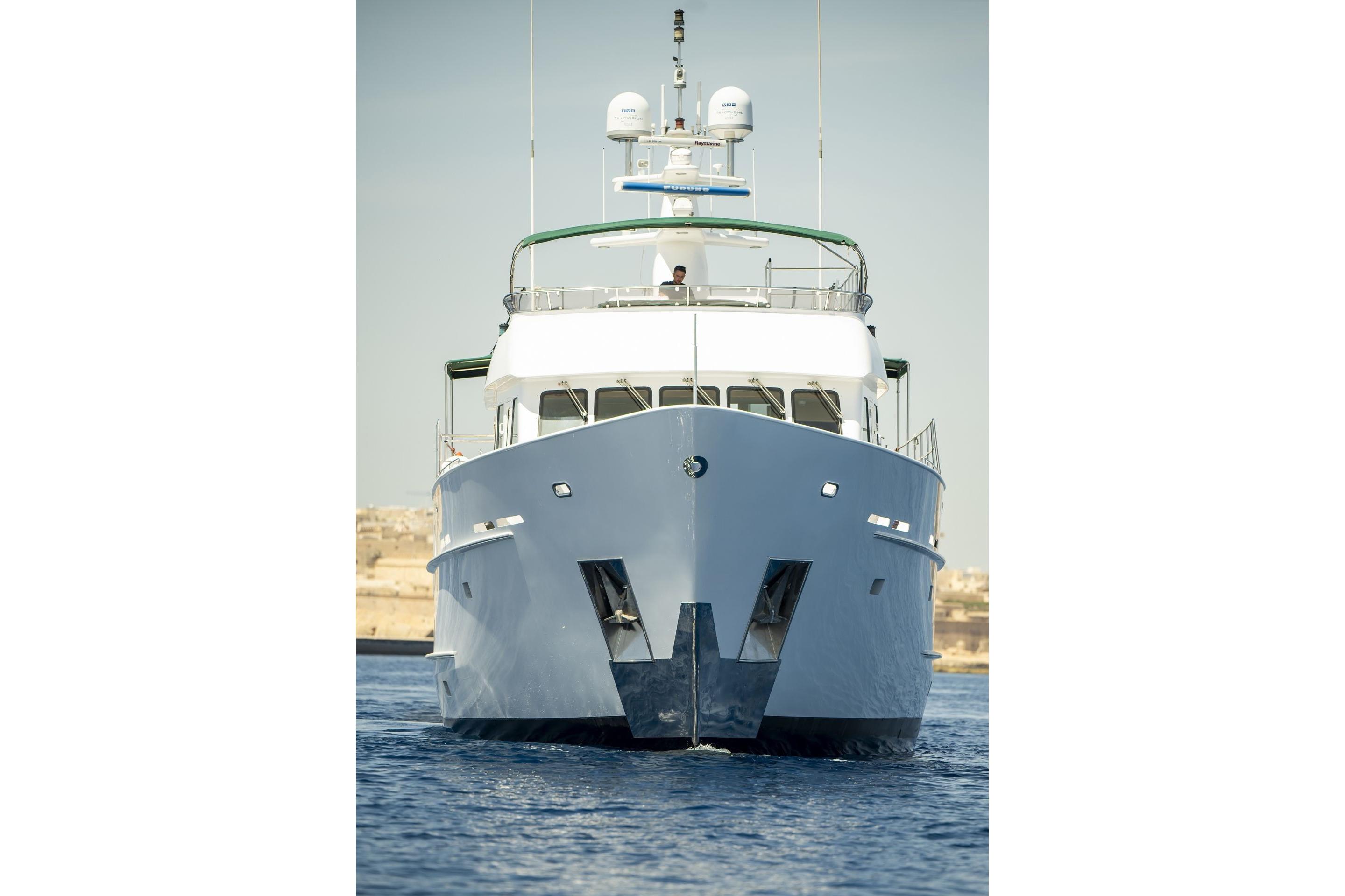 Front view of 2004 Explorer Seaton 85 yacht on calm water.